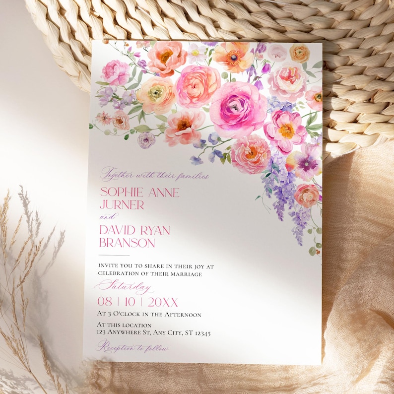 May include: A white wedding invitation card featuring a watercolor floral arrangement of pink, orange, and purple flowers at the top. The text reads: Together with their families, SOPHIE ANNE JURNER and DAVID RYAN BRANSON, INVITE YOU TO SHARE IN THEIR JOY AT CELEBRATION OF THEIR MARRIAGE, Saturday, 08 | 10 | 20XX, AT 3 O'CLOCK IN THE AFTERNOON, AT THIS LOCATION, 123 ANYWHERE ST, ANY CITY, ST 12345, Reception to follow.