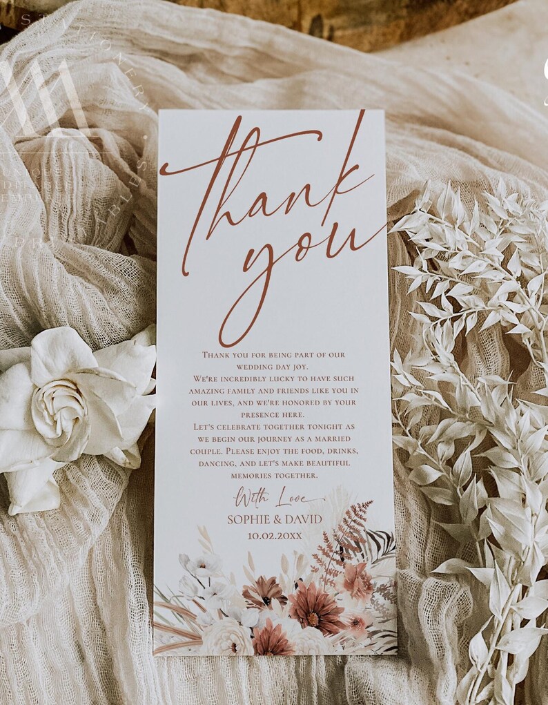 May include: A rectangular wedding thank you card featuring the text Thank you in a large rust-colored script font. Below, smaller text reads Thank you for being part of our wedding day joy, followed by With Love, Sophie & David, and 10.02.20XX.
