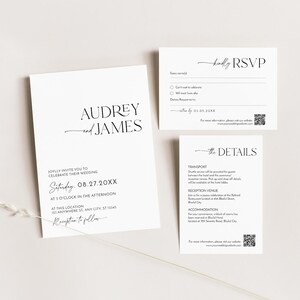 May include: A set of elegant white wedding stationery with black text. The invitation features the names "Audrey and James" and wedding details. The RSVP and details cards are also included, all with a minimalist design.