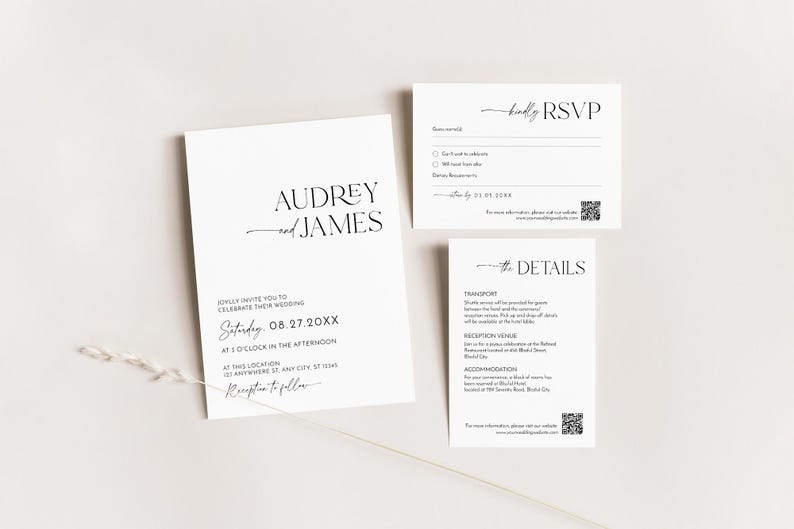 May include: A set of elegant white wedding stationery with black text. The invitation features the names "Audrey and James" and wedding details. The RSVP and details cards are also included, all with a minimalist design.