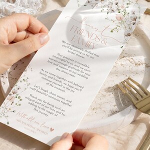 May include: A white rectangular bridal shower invitation card featuring a floral illustration at the top and bottom, with the text: Dear Friends & Family, We are absolutely thrilled that you'll be joining us for our bridal shower.