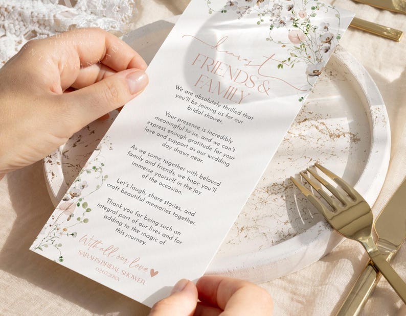 May include: A white rectangular bridal shower invitation card featuring a floral illustration at the top and bottom, with the text: Dear Friends & Family, We are absolutely thrilled that you'll be joining us for our bridal shower.