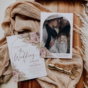 May include: A wedding invitation set featuring floral illustrations of roses and pampas grass. The text reads: The Wedding of Sarah and Thomas, Saturday 24 Sep, 20XX. Includes a photo card of a couple, a gold wax seal stamp, and two wax seals.
