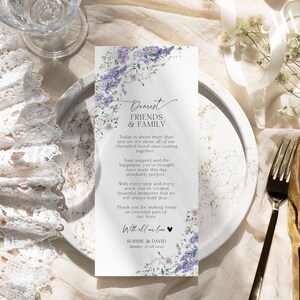 May include: A rectangular wedding program card featuring a watercolor floral border of purple lilacs and green leaves. The text reads Dearest Friends & Family, followed by a thank you message, the names Sophie & David, and the date Sunday, 27.08.20xx.