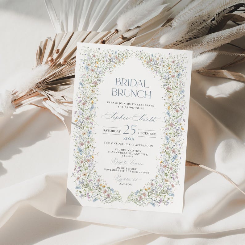 May include: A floral-themed bridal brunch invitation with a watercolor border of flowers. The invitation reads "Bridal Brunch" and includes the bride-to-be's name, Sophie Smith, the date, Saturday, December 25, 20XX, and the time, two o'clock in the afternoon. The invitation also includes the location, 143 Anywhere St., Any City, and the RSVP information, on or before November 5th at (123) 456-7890. The invitation is printed on a white background.