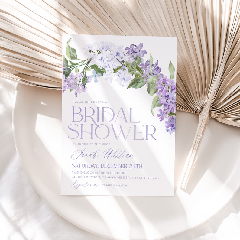 May include: A purple and green floral bridal shower invitation with the text 'Please join us for a Bridal Shower in honor of the bride Sarah William Saturday, December 24th Two o'clock in the afternoon at this location, 123 Anywhere St, Any City, ST 12345 Registers at Target & Amazon'