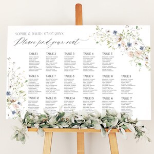 May include: A wedding seating chart with a floral design. The chart is printed on white paper and features a floral border with blue and pink flowers. The chart is divided into 17 tables, each with a table number and a list of names. The text at the top of the chart reads "Sophie & David 07/07/20XX Please find your seat."