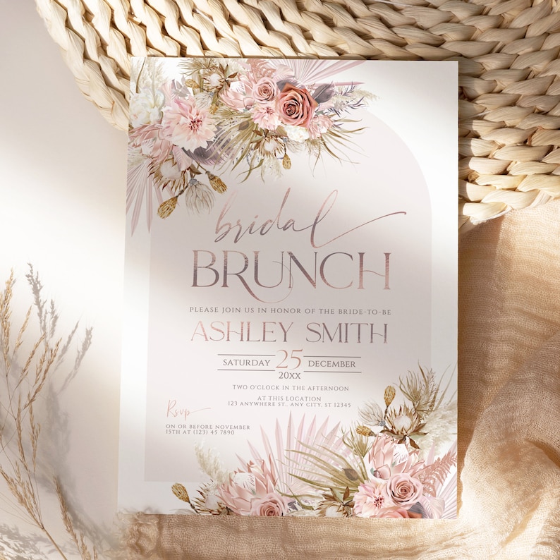 May include: A blush pink and gold bridal brunch invitation with a floral design. The text reads "bridal brunch" and "Please join us in honor of the bride-to-be Ashley Smith. Saturday 25 December 20xx. Two o'clock in the afternoon at this location 123 Anywhere St. Any City, ST 12345. RSVP on or before November 15th at (123) 45 7890."