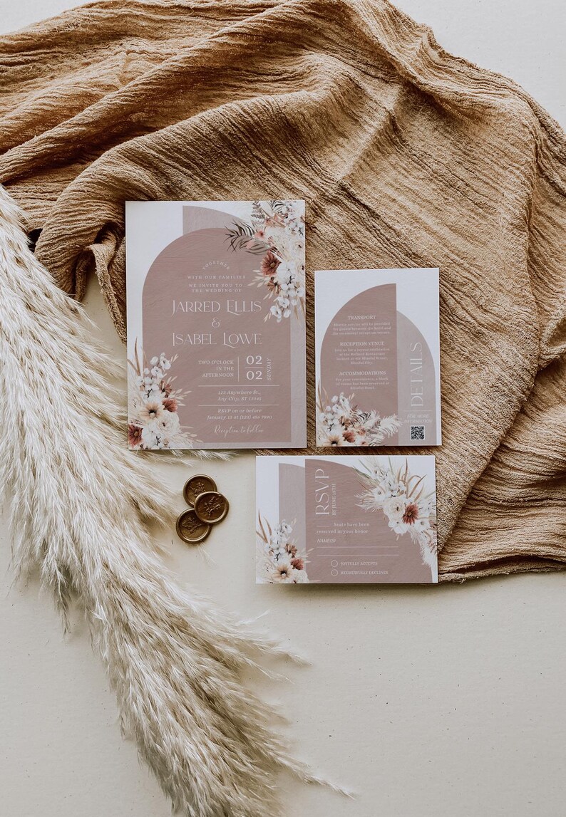 May include: Wedding invitation suite with a modern design featuring a dusty rose background with floral illustrations and a semi-circle shape. The text reads "Jarred Ellis & Isabel Lowe" and includes the date "02.02.2022".