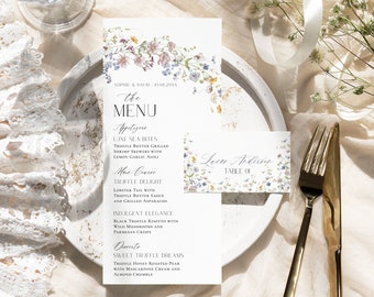 Könnte beinhalten: Eine Hochzeitsmenükarte mit floralen Designs und dem Text "the MENU" in einer dekorativen Schriftart. Das Menü umfasst Vorspeisen, Hauptgerichte und Dessert-Optionen. Die Karte enthält auch eine Platzkarte mit dem Text "Lucar Anderson TABLE 01" und floralen Designs.