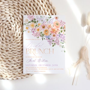 May include: A bridal brunch invitation with a watercolor floral design in shades of pink, purple, and yellow. The text reads "Please join us for a Bridal Brunch in honor of the bride Sarah William Saturday, December 24th Two o'clock in the afternoon at this location - 121 Anywhere, Any St., Any City 12345 Register at Target & Amazon"