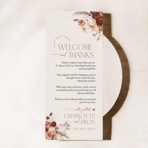 Puede incluir: Una tarjeta de bienvenida de boda rectangular con ilustraciones florales en burdeos y crema en la parte superior e inferior. El texto dice WELCOME and THANKS, seguido de un mensaje de gratitud, los nombres CHARLOTTE and JASON y la fecha 27TH JUNE 20XX.