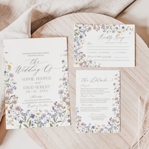 May include: Wedding invitation suite with a floral design featuring a variety of wildflowers in shades of blue, purple, pink, and yellow. The text on the cards reads "The Wedding of Sophie Hooper and David Robert 08.10.20XX Saturday at 6 o'clock in the evening at Nowhere St, Any City, ST 12345 Reception to follow".