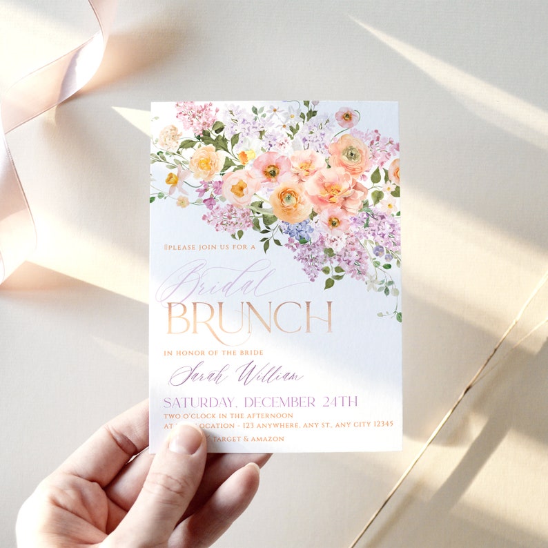 May include: A white invitation with a floral design in shades of pink, purple, and yellow. The text reads "Please join us for a Bridal Brunch in honor of the bride Sarah William Saturday, December 24th Two o'clock in the afternoon at Location 123 Anywhere, Any St. Any City 12345 Target & Amazon".