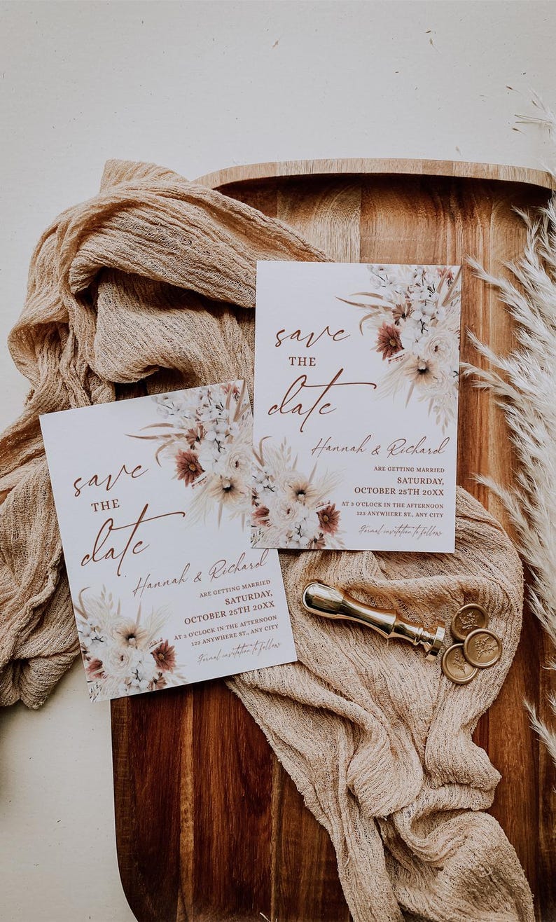 May include: Save the date cards with a floral design and the text "Save the Date" and "Hannah & Richard" are getting married on Saturday, October 25th 20XX at 5 o'clock in the afternoon. 125 Anywhere St, Any City.