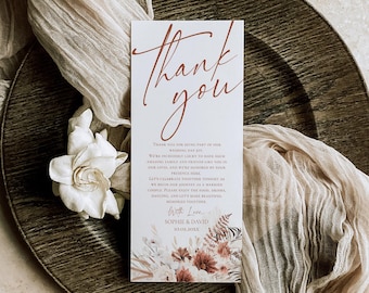 May include: A rectangular wedding thank you card with white background and rust-colored script text reading Thank you. The card features printed floral illustrations at the bottom and text including the names Sophie and David with date 10.02.20XX.