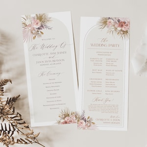 May include: A wedding ceremony program with a floral design featuring pink and purple flowers, greenery, and gold accents. The program includes the names of the bride and groom, Charlotte Anne Jurner and Jason Ryan Branson, and the date of the wedding, Sunday, 07.08.20XX. The program also includes the order of the ceremony and a list of the wedding party.