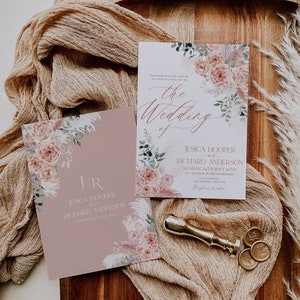 May include: A wedding invitation suite with a floral design. The invitation features a pink and white floral pattern with greenery and a gold foil accent. The text on the invitation reads "Together with our families, we joyfully invite you to the wedding of Jesica Hooper and Richard Anderson, Sunday, 24th July 20XX, at 5 o'clock in the afternoon, Anywhere, Any Street, Any City. Reception to follow."