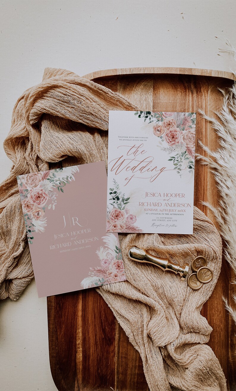 May include: A wedding invitation suite with a floral design. The invitation features a pink and white floral pattern with greenery and a gold foil accent. The text on the invitation reads "Together with our families, we joyfully invite you to the wedding of Jesica Hooper and Richard Anderson, Sunday, 24th July 20XX, at 5 o'clock in the afternoon, Anywhere, Any Street, Any City. Reception to follow."