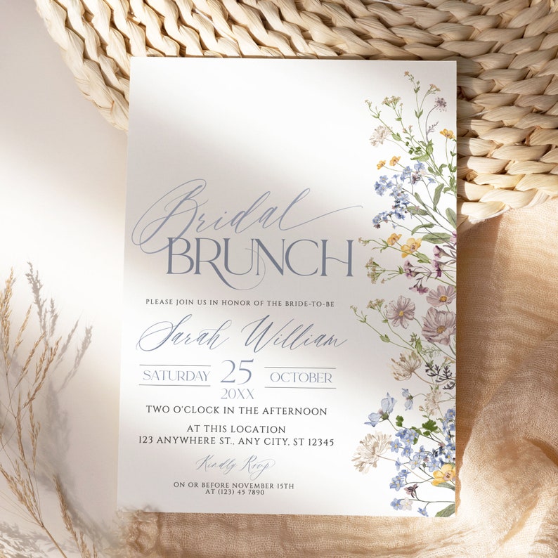 May include: A white bridal brunch invitation with blue and purple floral illustrations. The text reads "Bridal Brunch", "Please join us in honour of the bride-to-be Sarah William", "Saturday 25 October 20XX", "Two o'clock in the afternoon", "At this location 123 Anywhere St., Any City, ST 12345", "Kindly RSVP on or before November 15th at (123) 45 7890".