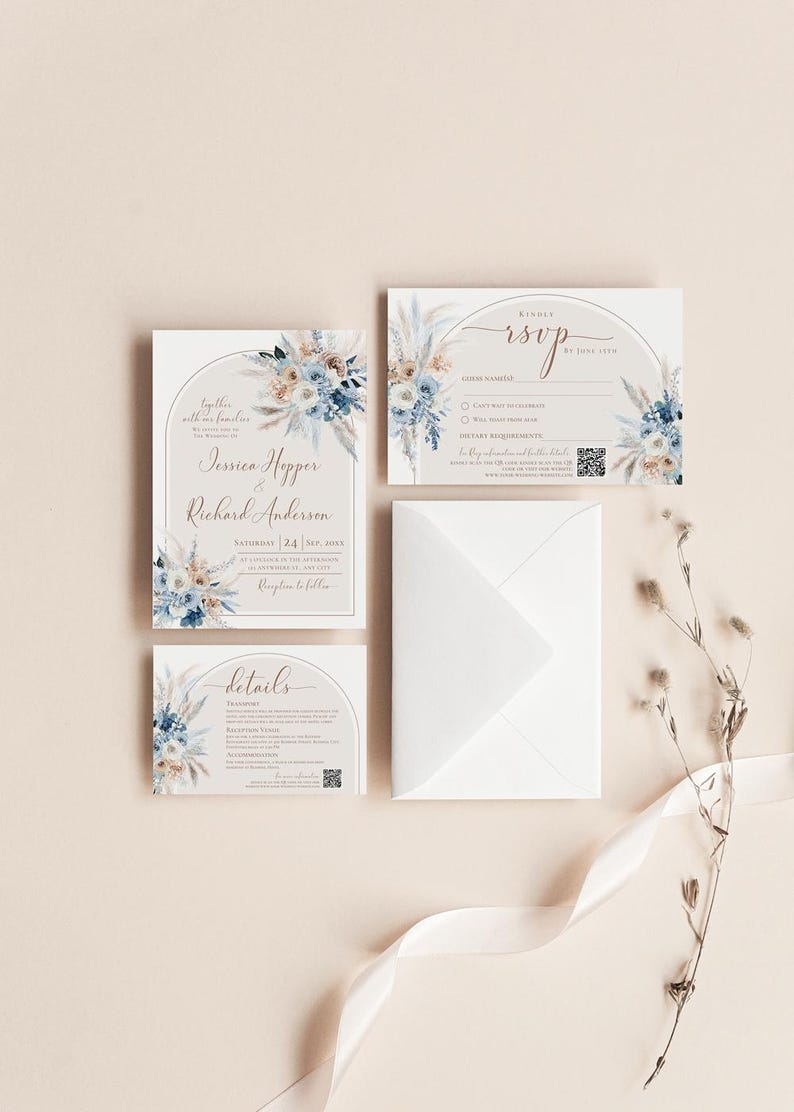 May include: A wedding stationery set featuring an invitation, RSVP card, and details card, all adorned with blue and beige floral illustrations and arched frames. A white envelope and a dried floral stem are included in the arrangement.