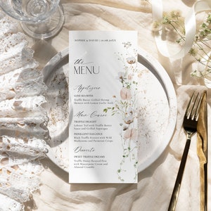 May include: A vertical white menu card featuring the text SOPHIE & DAVID | 10.08.20XX, the MENU, Appetizers, Main Course, and Desserts. The card is decorated with a delicate watercolor illustration of wildflowers in soft pink, white, and green tones.