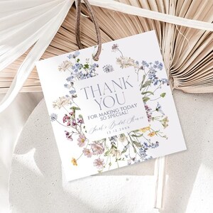 May include: White thank you card with a floral design featuring blue, pink, and yellow flowers. The text on the card reads "Thank You for making today so special!" and "[Name]'s Bridal Shower [Date]"