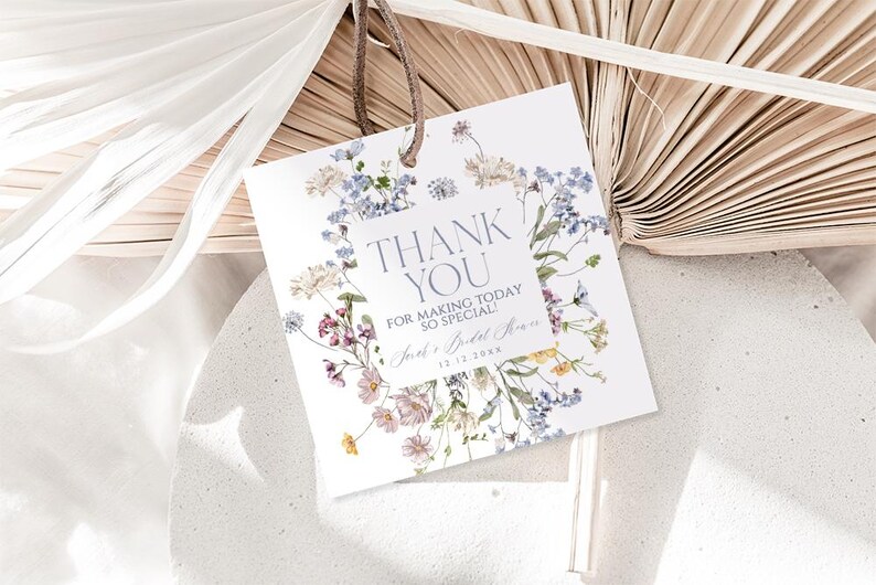 May include: White thank you card with a floral design featuring blue, pink, and yellow flowers. The text on the card reads "Thank You for making today so special!" and "[Name]'s Bridal Shower [Date]"