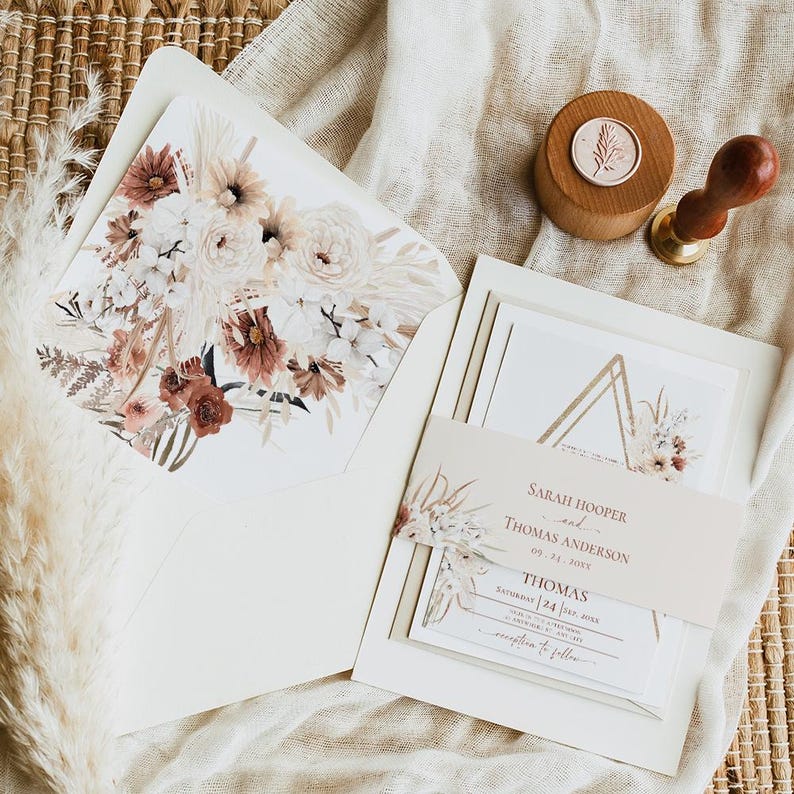 May include: A wedding invitation suite with a geometric design and floral accents. The invitation features a gold triangle with a floral illustration and the text "Sarah Hooper and Thomas Anderson, 09.24.2023, Saturday | Five O'Clock, at [Location], reception to follow".