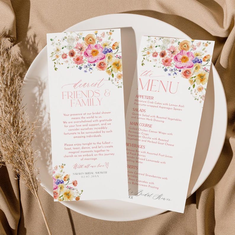 Op de afbeelding: Een bloemig bruidsdouchemenu met een roze en witte achtergrond. Het menu bevat voorgerechten, salades, hoofdgerecht, dranken en desserts. De tekst "the dearest friends & family" staat bovenaan het menu.