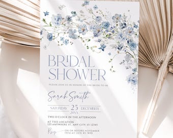 May include: A white rectangular bridal shower invitation card featuring a watercolour floral arrangement of blue flowers and green foliage at the top. The text reads Bridal Shower, Please join us in honour of the bride-to-be, Sarah Smith, Saturday 25 December 20XX.