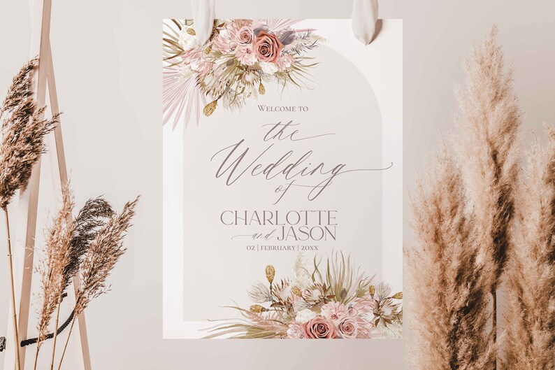 May include: A wedding welcome sign with a floral design in shades of pink and beige. The sign reads "Welcome to the Wedding of Charlotte and Jason 02 | February | 20XX".