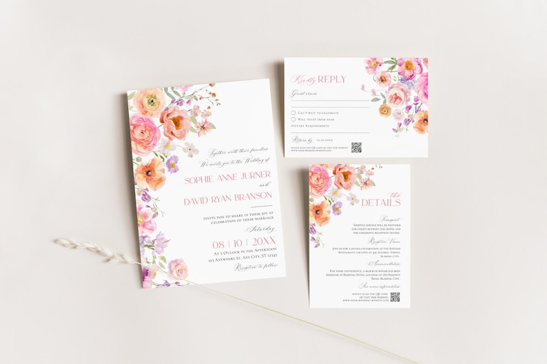 May include: A wedding invitation suite featuring a main invitation, a reply card, and a details card. Each white card displays pink text and watercolor floral illustrations in shades of pink, orange, and purple. A thin, light-colored twig lies across the bottom.