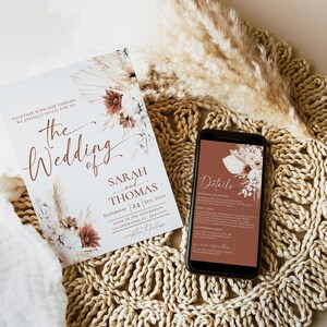 May include: A wedding invitation card and a smartphone displaying event details. The card features floral illustrations, the text 'The Wedding of Sarah and Thomas', and date information. The phone screen shows matching floral graphics and text.