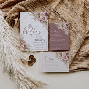 May include: A wedding invitation suite featuring a main invitation, a details card, and an RSVP card, all decorated with floral and pampas grass illustrations. Three gold wax seals are included, with text detailing the wedding of Sarah and Thomas.