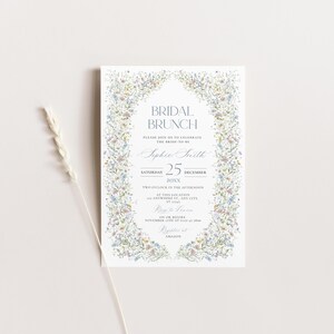May include: A white invitation with a floral border. The text reads "Bridal Brunch" and "Please join us to celebrate the bride-to-be Sophie Smith" with the date "Saturday, December 25, 20XX".