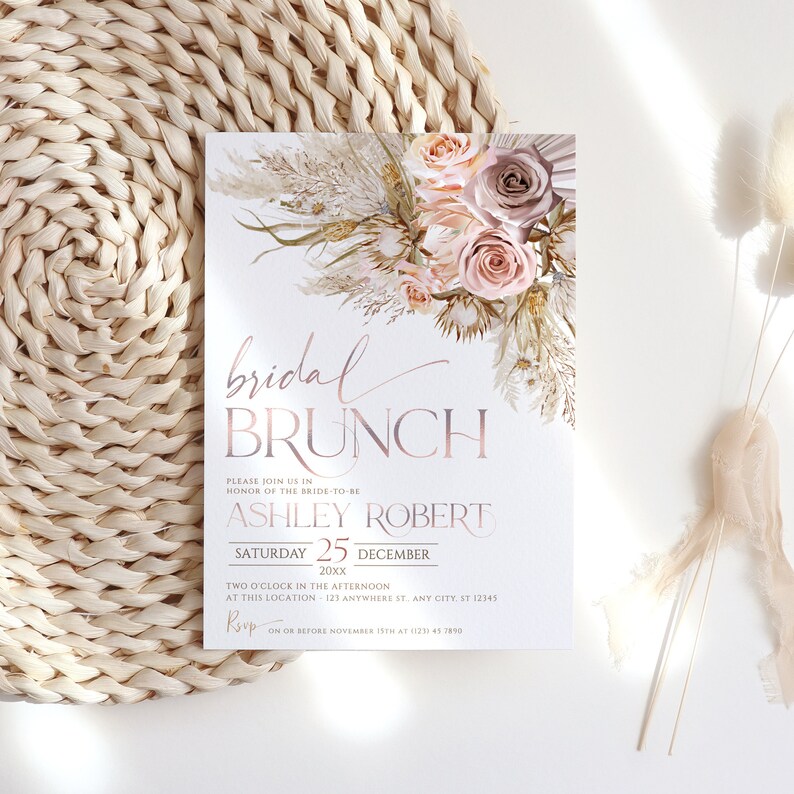 May include: A blush pink and cream bridal brunch invitation with a floral design and gold accents. The text reads "bridal brunch" and includes the bride-to-be's name, the date, and RSVP information.