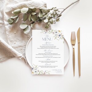 May include: A floral-themed wedding menu with a white background and blue and green floral accents. The menu lists appetizers, main course, salad, and dessert options. The text at the bottom reads "Charlotte & Jason 4th June 2023".