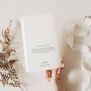May include: A white folded thank you card featuring black printed text that reads: THANK YOU, We would like to thank our family and friends for your love and support. We feel so grateful to have each and every one of you in our lives. Thank you for sharing in our special day, it means the world to us that you could be here. with love, SOPHIE & DAVID, Sunday, 27.08.2023.