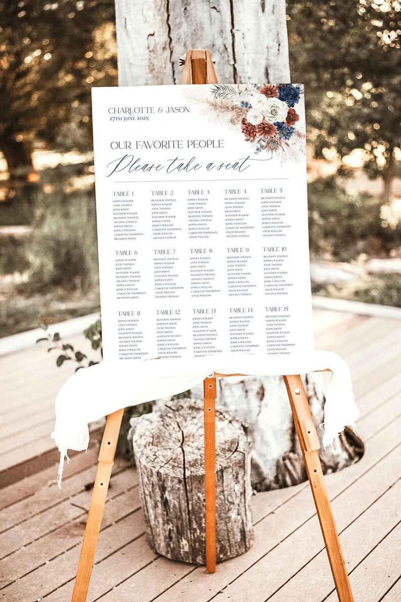 May include: A wedding seating chart with a floral design in shades of blue, red, and white. The chart lists tables 1 through 15 with guest names. The text reads "Charlotte & Jason, 27th June 202X, Our Favorite People, Please take a seat."