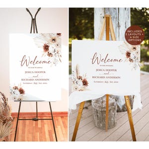 May include: A white wedding welcome sign featuring dark brown text that reads Welcome to our wedding Jesica Hooper and Richard Anderson Saturday 24 Sep 20xx. The sign is decorated with dried pampas grass and brown and white floral arrangements.