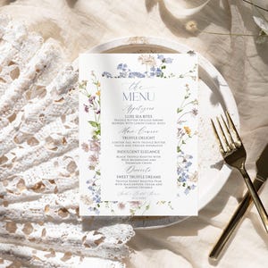 Puede incluir: Una tarjeta de men&uacute; rectangular con un delicado borde floral de acuarela en tonos azules, amarillos y rosas. El texto dice: THE MENU, Appetizers, LUXE SEA BITES, TRUFFLE BUTTER GRILLED SHRIMP SKEWERS WITH LEMON GARLIC AIOLI, Main Course, TRUFFLE DELIGHT, LOBSTER TAIL WITH TRUFFLE BUTTER SAUCE AND GRILLED ASPARAGUS, INDULGENT ELEGANCE, BLACK TRUFFLE RISOTTO WITH WILD MUSHROOMS AND PARMESAN CRISPS, Desserts, SWEET TRUFFLE DREAMS, TRUFFLE HONEY ROASTED PEAR WITH MASCARPONE CREAM AND ALMOND CRUMBLE, Sarah's Bridal Shower, 10.12.20XX.