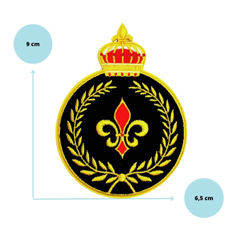 May include: A gold embroidered patch with a black background. The patch features a gold crown with a red jewel on top, a gold fleur-de-lis with a red center, and a gold laurel wreath. The patch measures 6.5 cm in diameter and 9 cm in height.