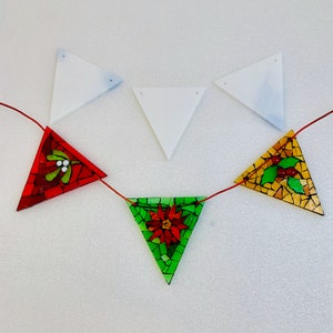 May include: A red, green and gold mosaic Christmas garland with a red holly berry, a green poinsettia and a gold holly berry design. The garland is strung on white string and is ready to be hung.