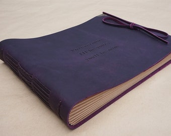 May include: A deep purple leather-bound journal with a decorative closure and a ribbon tie. The cover is embossed with the text "Forevermore I'll be yours you'll be mine".