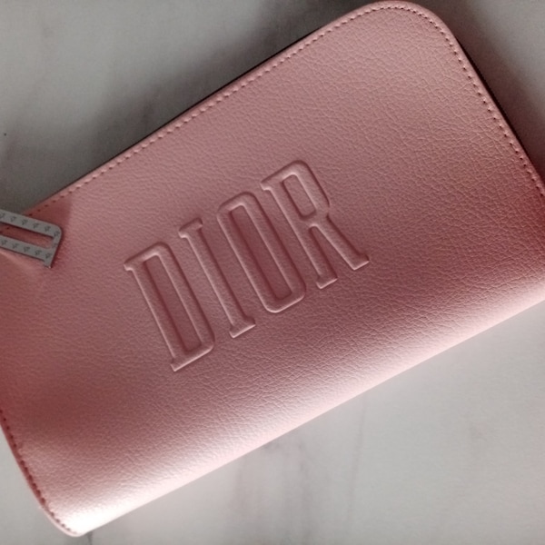 DIOR soft baby pink faux leather half moon make up bag with big D zipper and washable liner