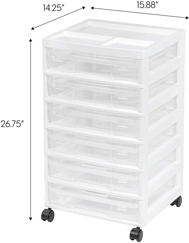 May include: White plastic 6-drawer rolling storage cart with clear drawers. The cart measures 14.25 inches wide, 15.88 inches deep, and 26.75 inches tall.