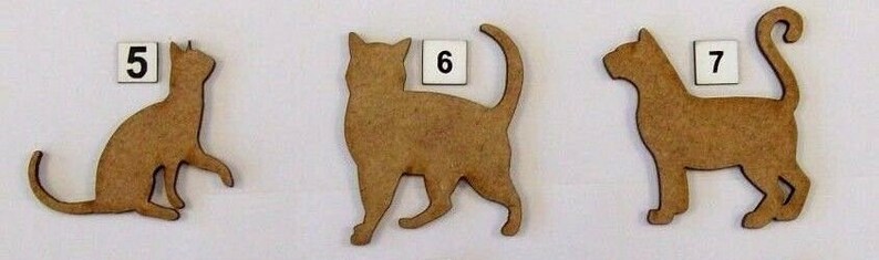 May include: Three wooden cat cutouts, each with a different pose. The cat cutouts are brown and have a natural wood finish. The cutouts are numbered 5, 6, and 7.