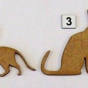 May include: Four wooden cat silhouettes, each with a different pose. The cats are numbered 1 through 4.