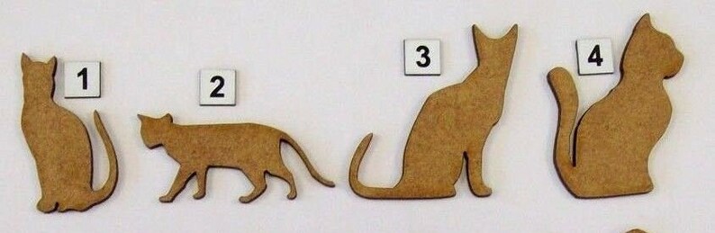 May include: Four wooden cat silhouettes, each with a different pose. The cats are numbered 1 through 4.